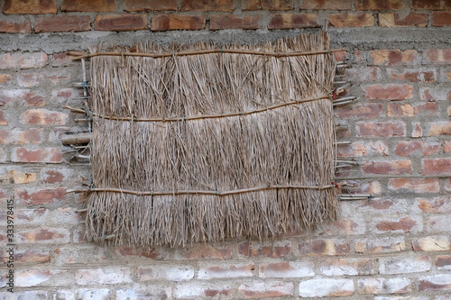 Straw window on mud house in Kumrokhali, West Bengal, India photo