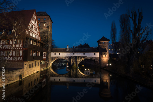 Illuminated Henkersteg bridge after dark in Nurnberg, Bavaria, Germany. Cityscape image view from Maxbrücke