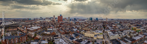 Aerial view with dramatic sky of various downtown Baltimore Maryland neighborhoods USA