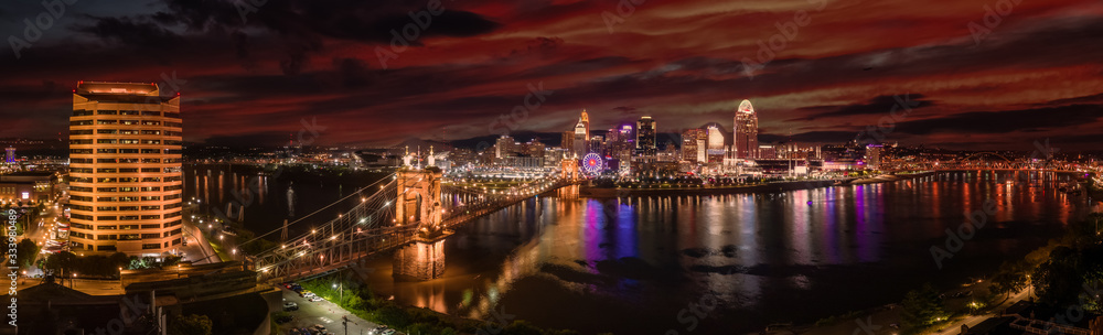 Aerial night time view of Cincinnati with the Roebling bridge stretching over the Ohio river 