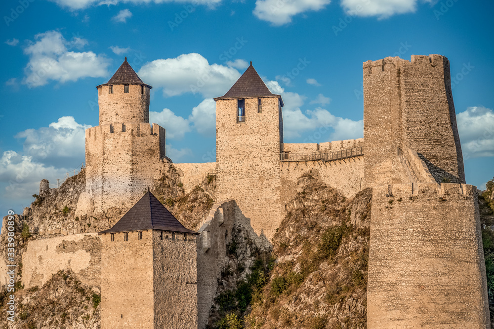 View of newly restored former Ottoman stronghold Golubac castle  with square and rectangular towers along the Danube river in Serbia on the border with Romania
