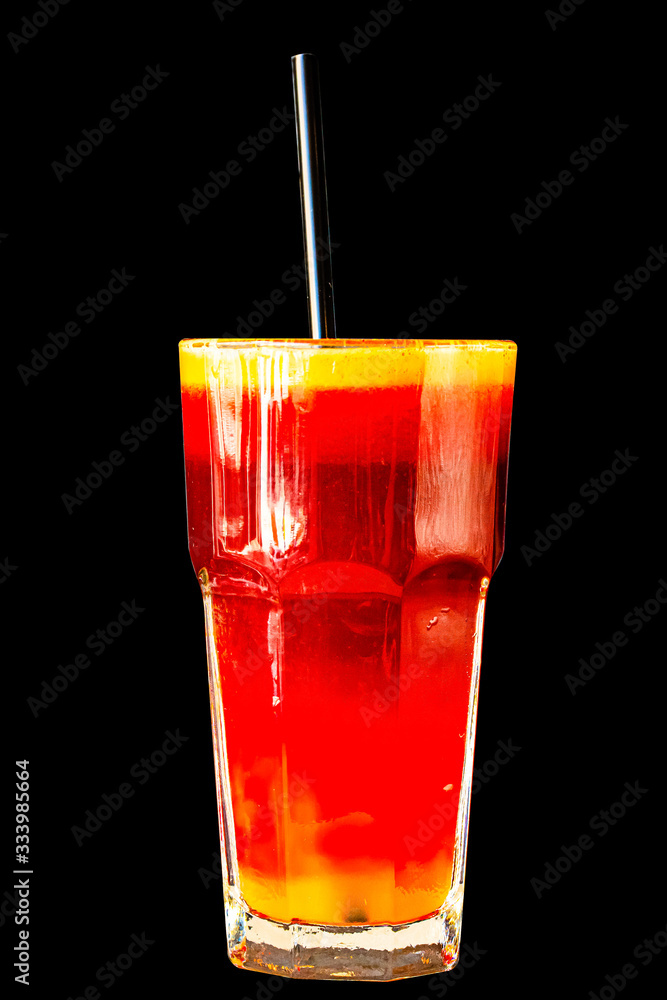 Red berry smoothie in a large glass glass on a black background, isolated Red berry smoothie in a large glass glass on a black background, isolated