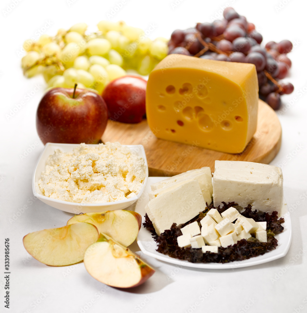 cheese, cottage cheese, apples and grapes on a kitchen table