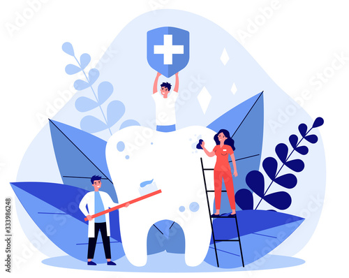 Tiny people cleaning big tooth flat vector illustration. Man holding banner with medical symbol. Doctor and dentist brushing teeth with toothbrush. Stomatology and healthcare concept.