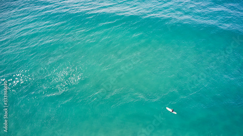 longboarder waiting in blue water photo
