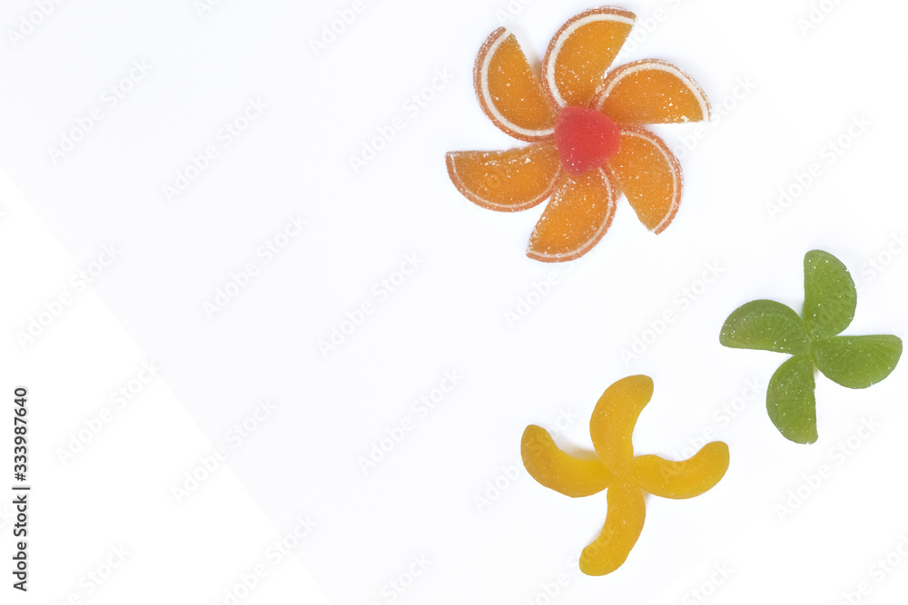 Fototapeta premium Multi-colored slices of fruit marmalade laid in the form of flowers