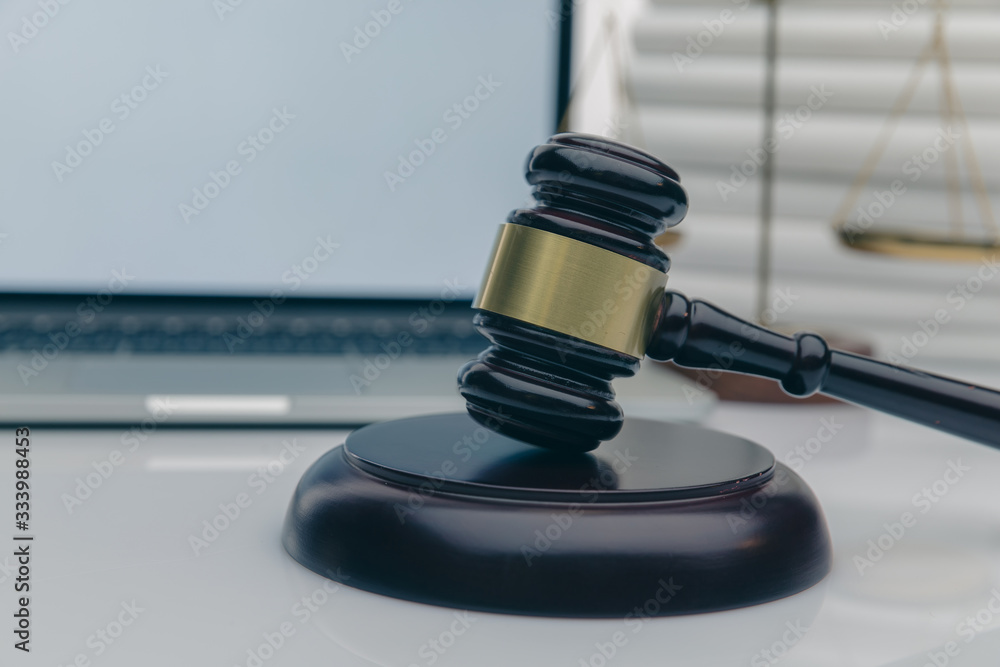 Workspace of lawyer with laptop blank white screen and law wooden gavel,legal book and brass scale of judge. lawyer and law ,judiciary and legislature courtroom legal concept. Workspace of lawyer with laptop blank white screen and law wooden gavel,legal book and brass scale of judge. lawyer and law ,judiciary and legislature courtroom legal concept.