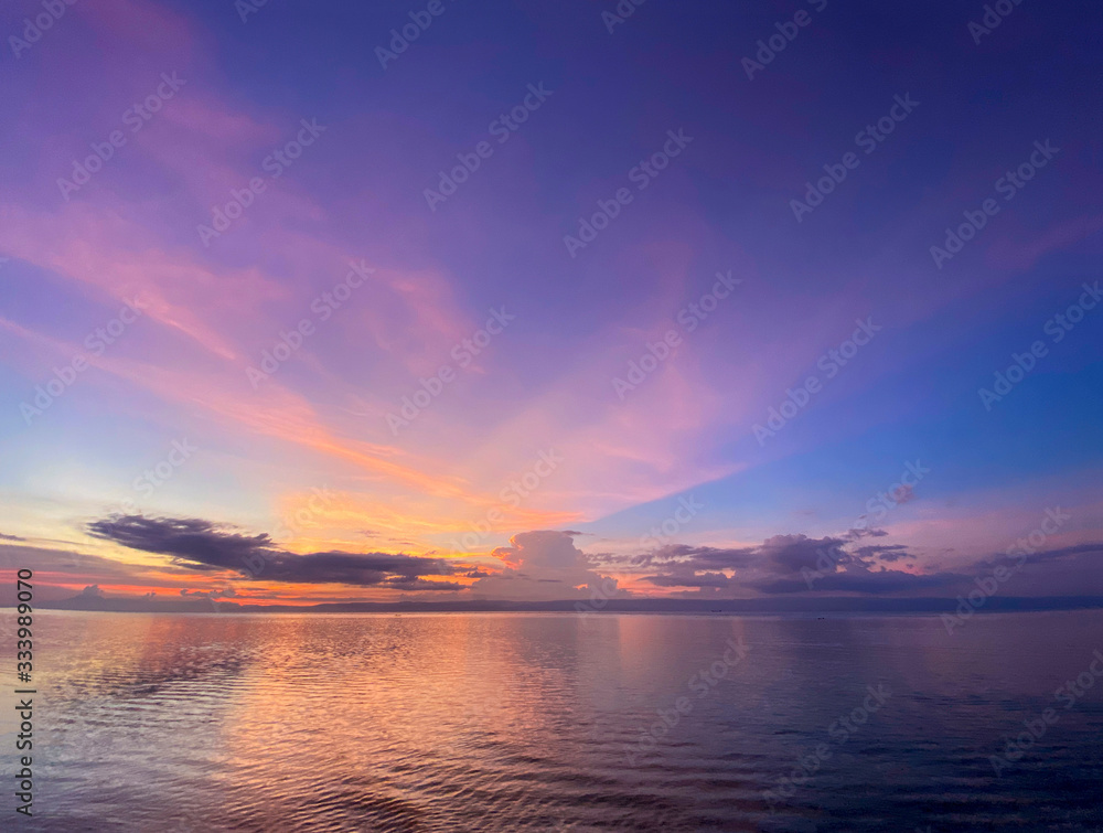 Colorful beautiful sunset,dawn.Calm sea with reflection of clouds in water.