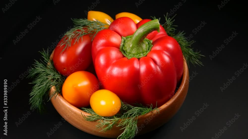 Yellow and red tomatoes, sweet peppers and greens for salad preparation Yellow and red tomatoes, sweet peppers and greens for salad preparation