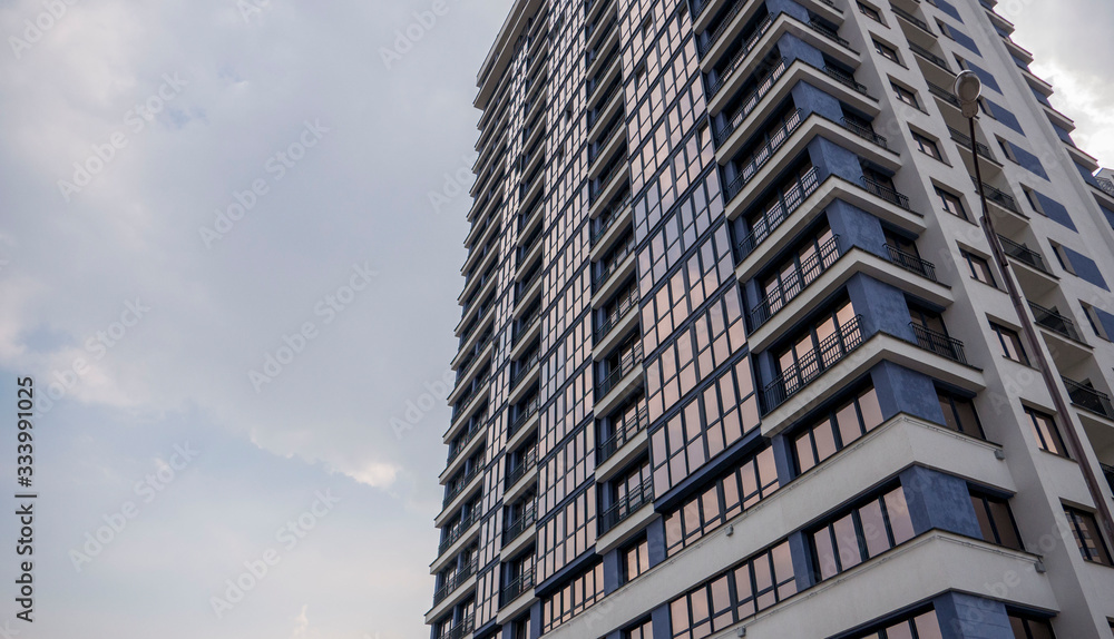 building facade reflection in glasses against the sky