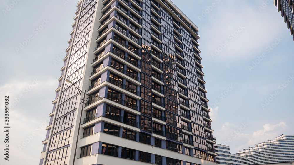 Fototapeta premium building facade reflection in glasses against the sky