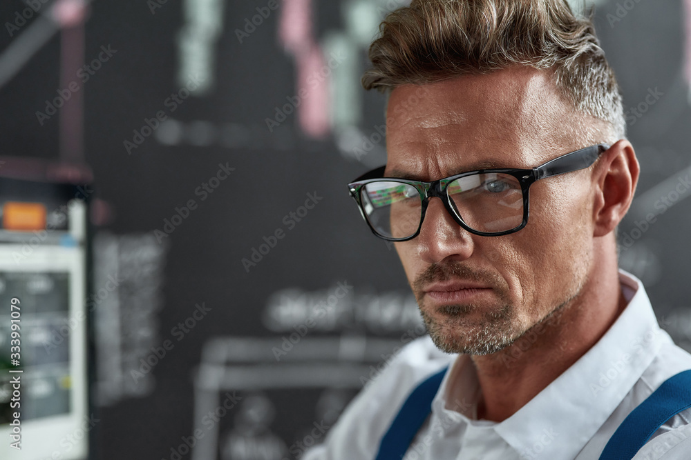 Be confident. Close up of middle-aged caucasian trader in glasses looking focused while working in the office. Be confident. Close up of middle-aged caucasian trader in glasses looking focused while working in the office.