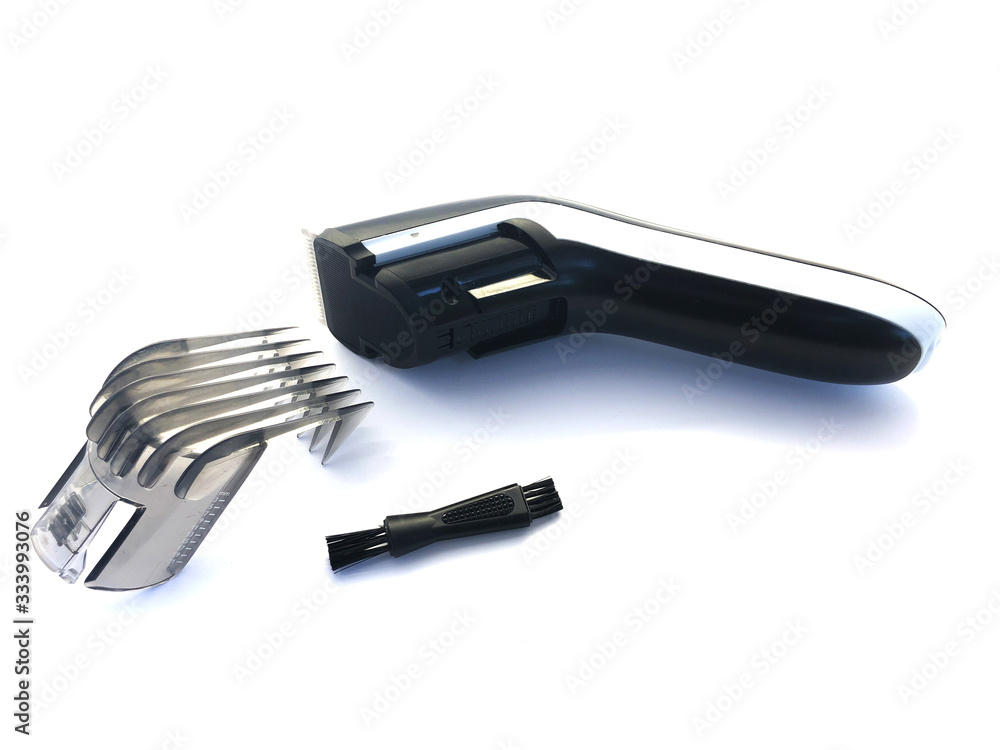 Hairdressing machine for cutting hair isolated on a white background. Hair clipper and nozzle. Set for cutting hair. Electric machine for a beauty salon. Tool for male hair cutting. Hairdressing machine for cutting hair isolated on a white background. Hair clipper and nozzle. Set for cutting hair. Electric machine for a beauty salon. Tool for male hair cutting.