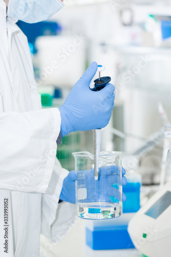 scientist in laboratory pipetting