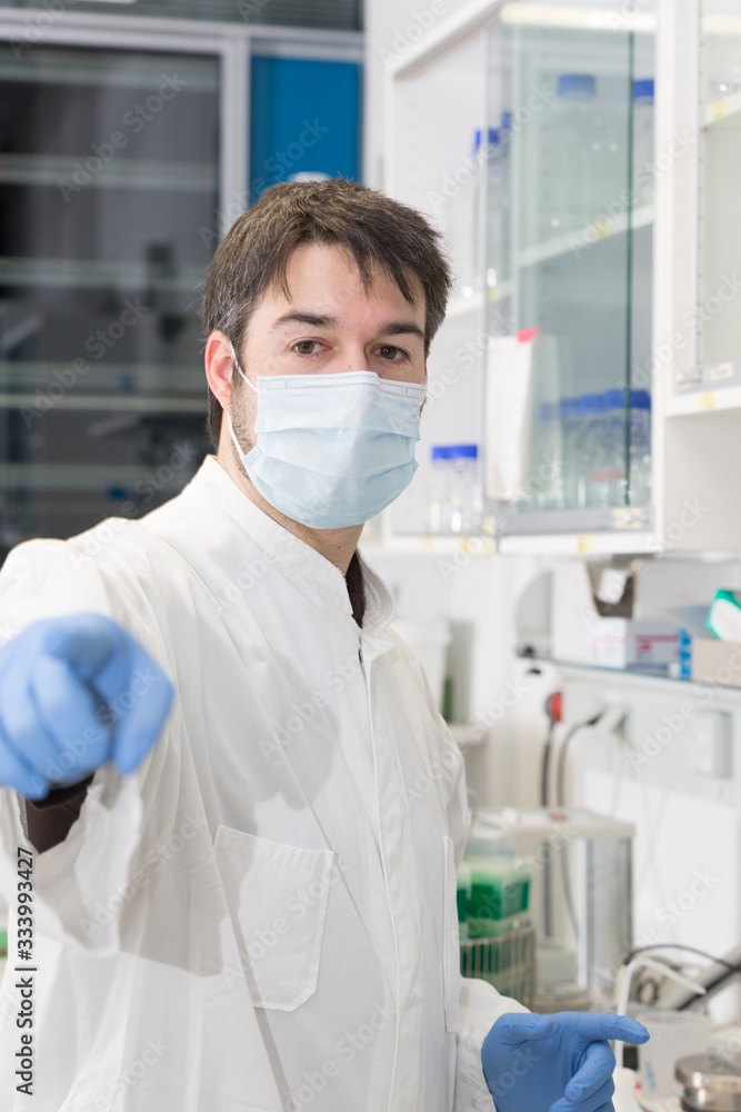 man working in the lab pointing finger at camera man working in the lab pointing finger at camera