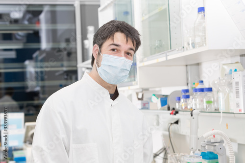 man with mouth protection in the laboratory