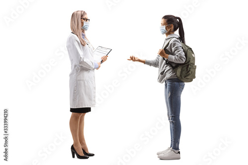 Female doctor and a female student wearing medical masks and talking