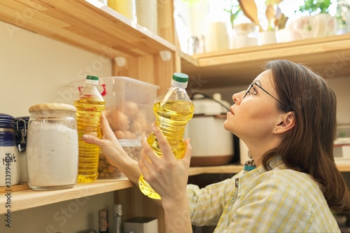 Food storage, woman taking food, sunflower oil for cooking