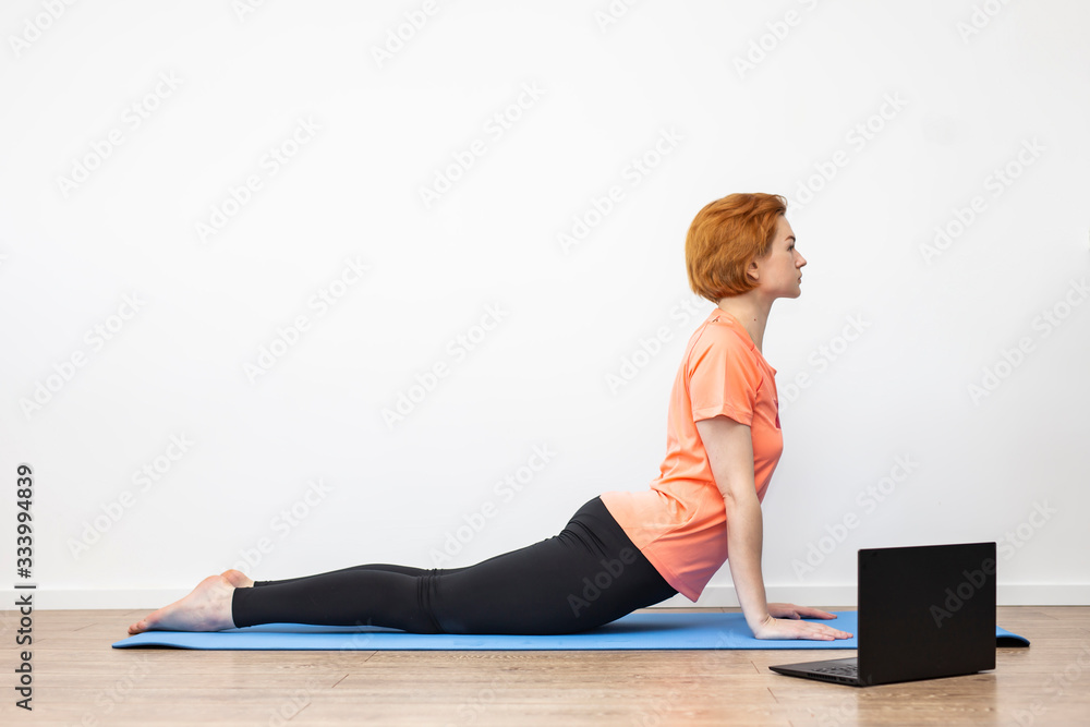 Fototapeta premium Yoga at home online.