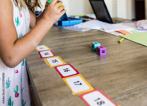 POV, Faceless child playing homeschool math game with number line and dice