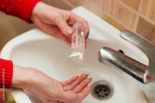 women wash their hands with alcohol gel or an antibacterial soap disinfectant
