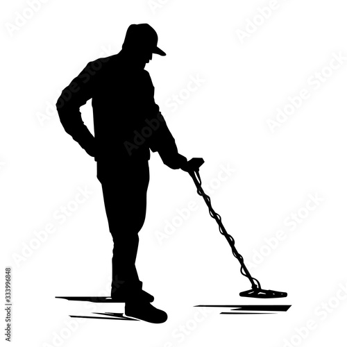 Silhouette man searches for treasures with a metal detector