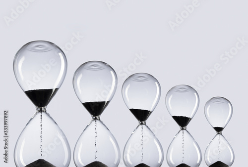 Hourglass on white background. Time is money. Collection of hourglasses with black sand showing the passage of time.