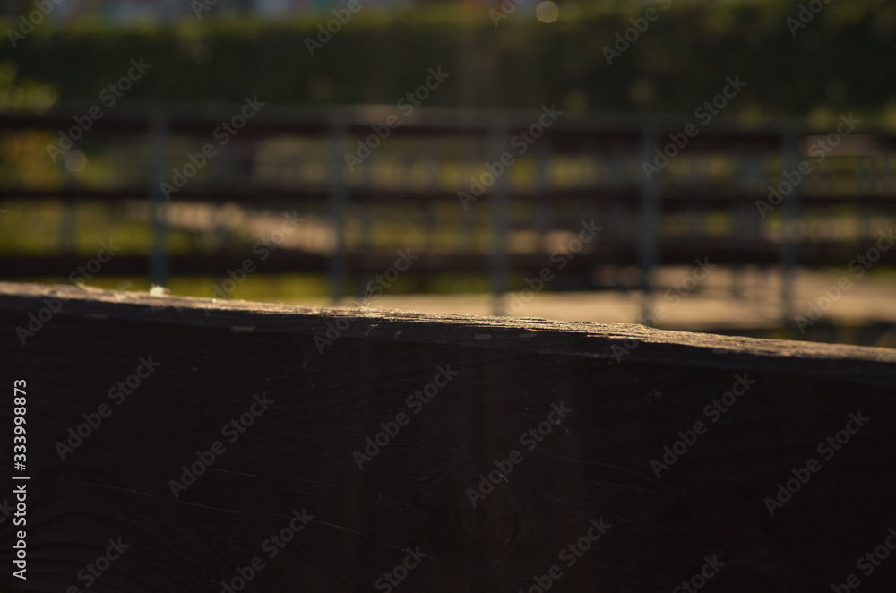wooden railings in the rays of sunset close-up wooden railings in the rays of sunset close-up