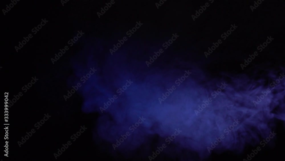Atmospheric smoke blue Fog effect. Haze background. Abstract smoke cloud. Smoke in slow motion on black background. White smoke slowly floating through space against black background. Atmospheric smoke blue Fog effect. Haze background. Abstract smoke cloud. Smoke in slow motion on black background. White smoke slowly floating through space against black background.