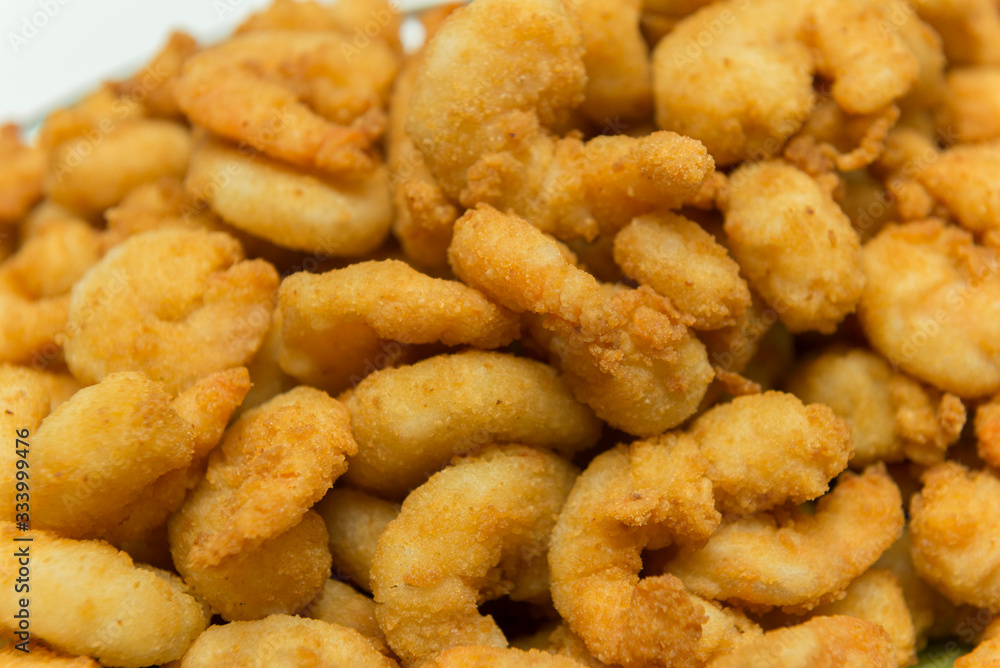 Closeup of delicious deep fried shrimps served with lime wedges and lettuce leaves Closeup of delicious deep fried shrimps served with lime wedges and lettuce leaves