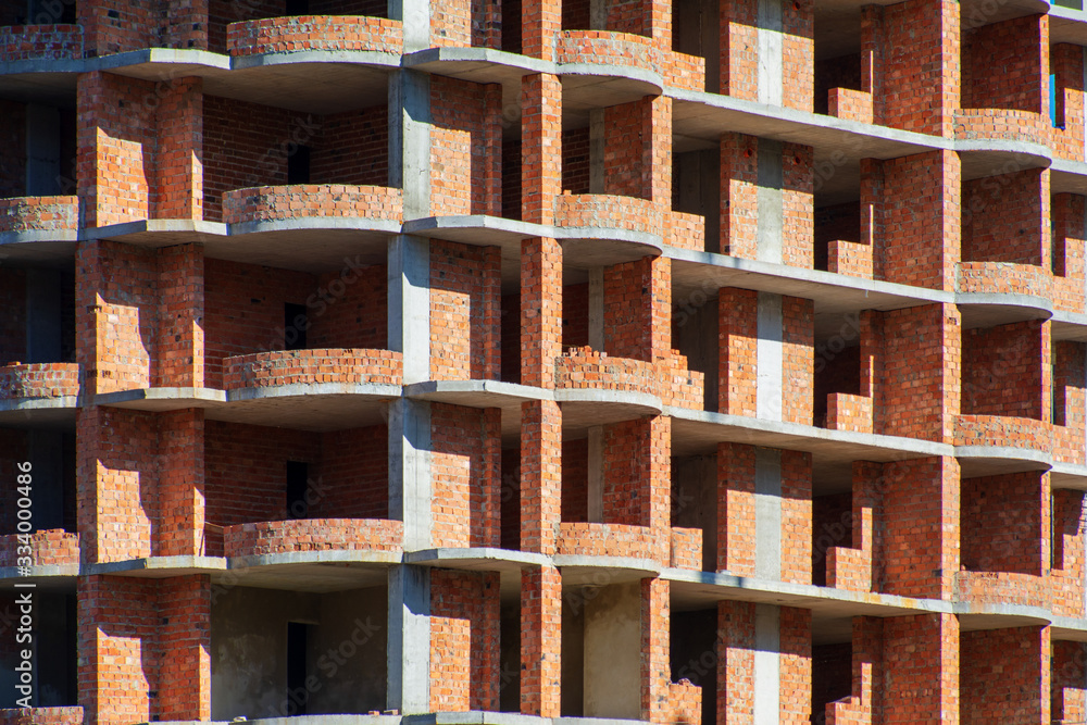 Unfinished brick multi-storey residential building, texture, background