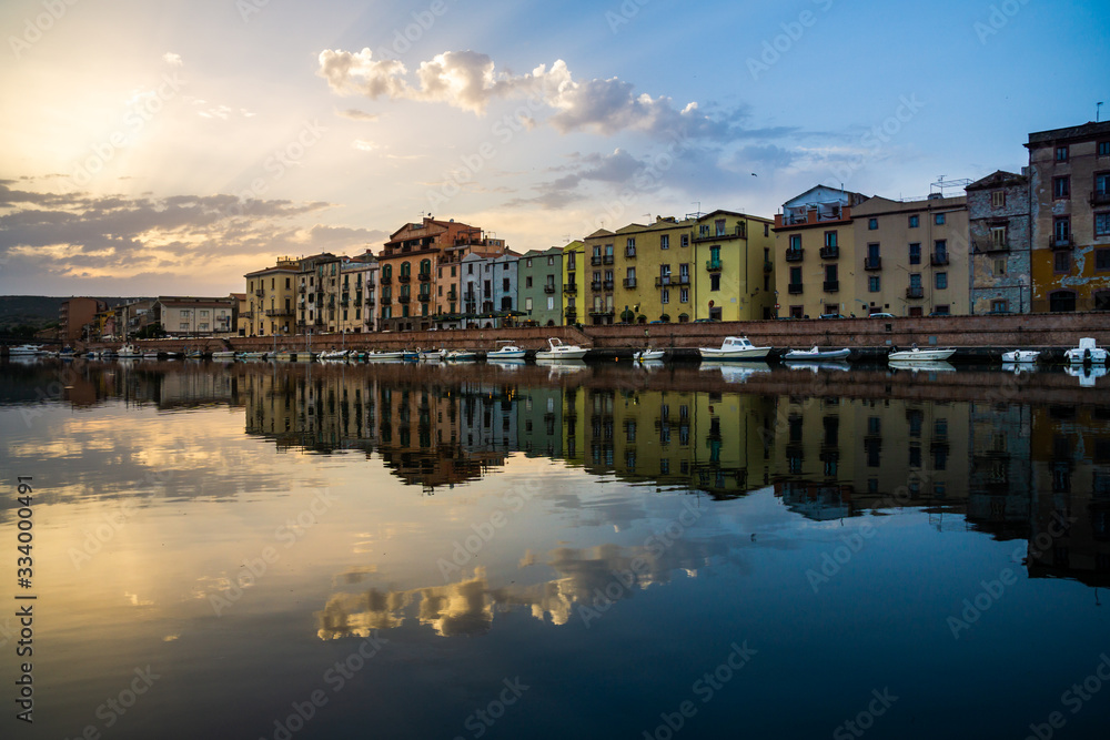 The Colorful Old buildings of Bosa reflected on the Temo River at Sunset, Sardinia