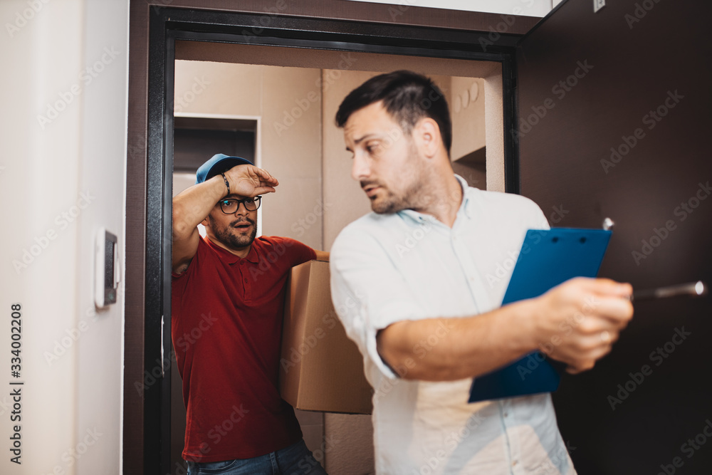 Young handsome man moving into new apartment. Young handsome man moving into new apartment.