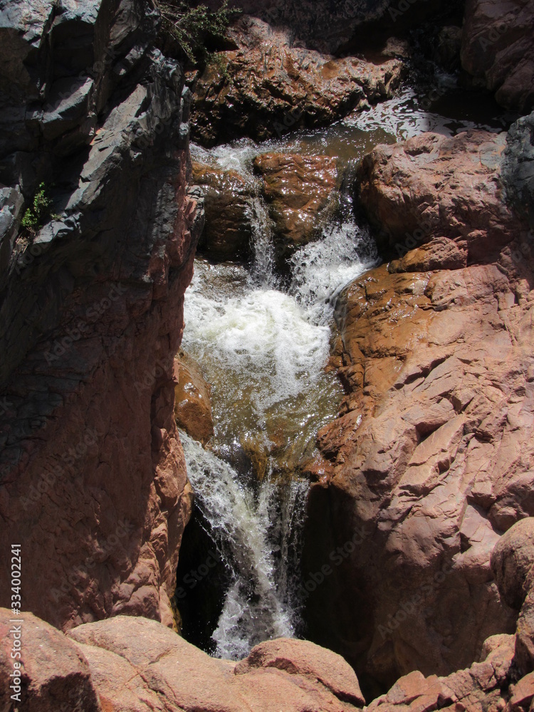 Closeup of a stream waterfall flowing down rocks on the Water Wheel Falls hiking trail in Payson, Arizona 