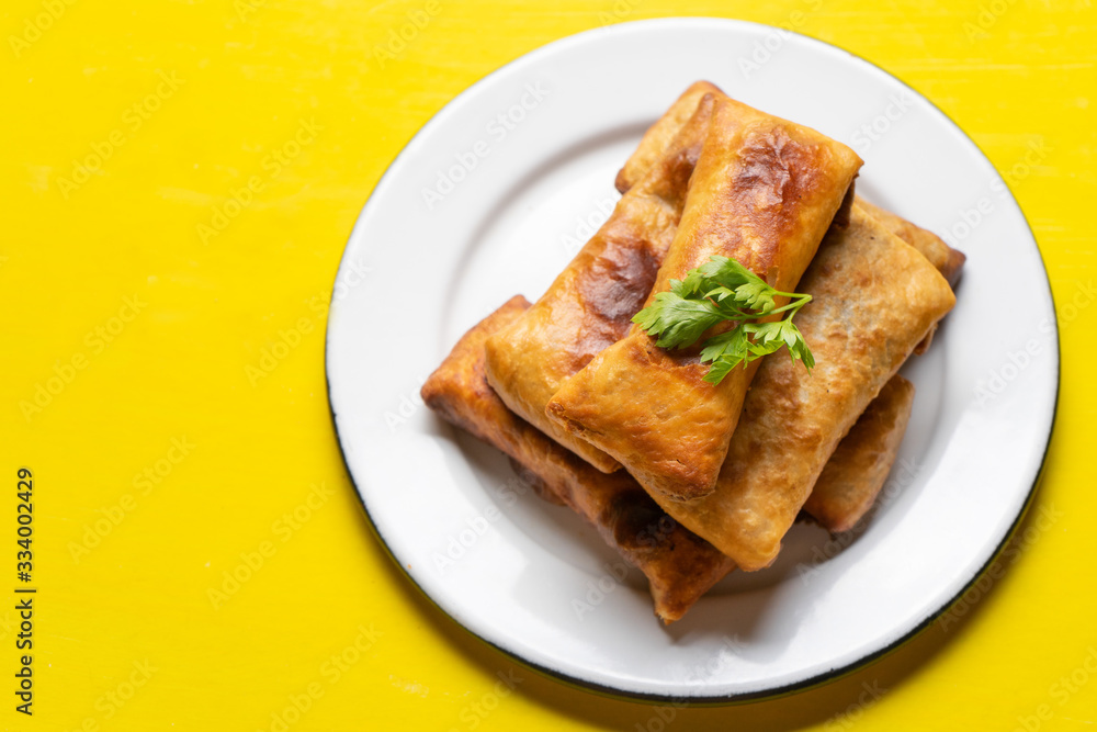 Mexican chimichanga on yellow background Mexican chimichanga on yellow background