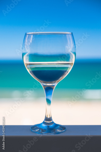 Glass of white wine on the background of the sea