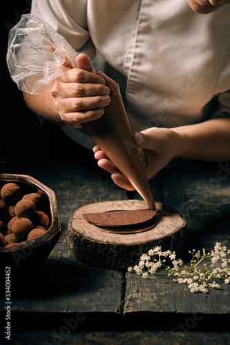 chef plating sweet dessert with pastry bag