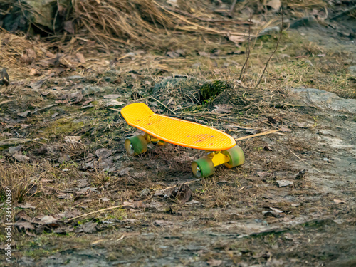 Yellow skate for riding on the ground. Roller board. Place for text. photo