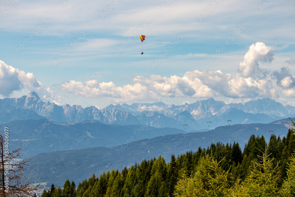 Panorama of the Austrian Alps,Europe,at Lake Ossiacher See with the mountains of the Karawanken Mountains with paragliders Panorama of the Austrian Alps,Europe,at Lake Ossiacher See with the mountains of the Karawanken Mountains with paragliders
