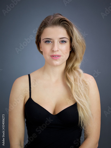 Portrait of nice pretty blonde lady isolated over grey background. Beauty and lifestyle concepts