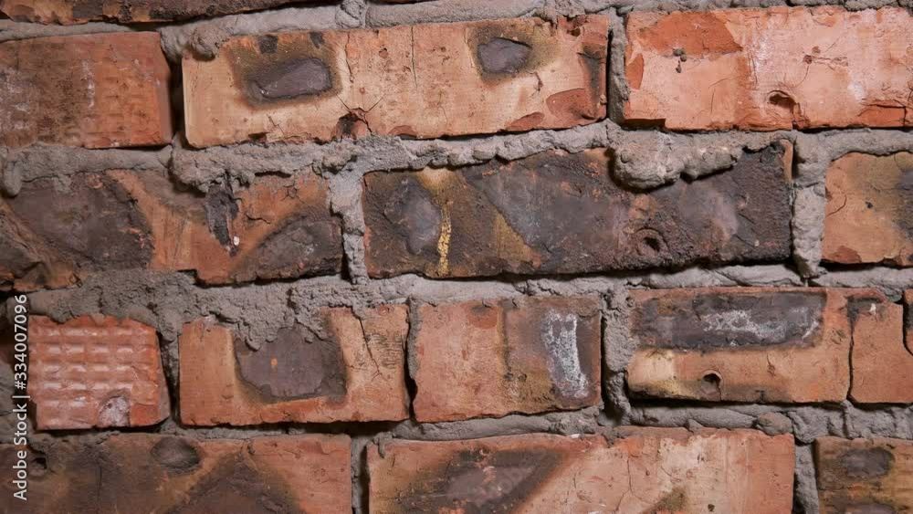 Brick wall close-up, uneven seams and inaccurate cement are visible, old masonry Brick wall close-up, uneven seams and inaccurate cement are visible, old masonry
