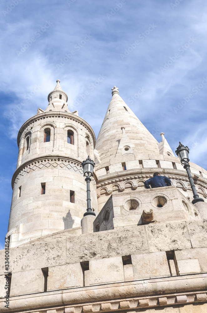 Fishermans Bastion in Budapest, Hungary. Major tourist attraction of the Hungarian capital city. Fairy tale monument, built in Neo-Romanesque style. Photographed from below, blue sky. Vertical photo