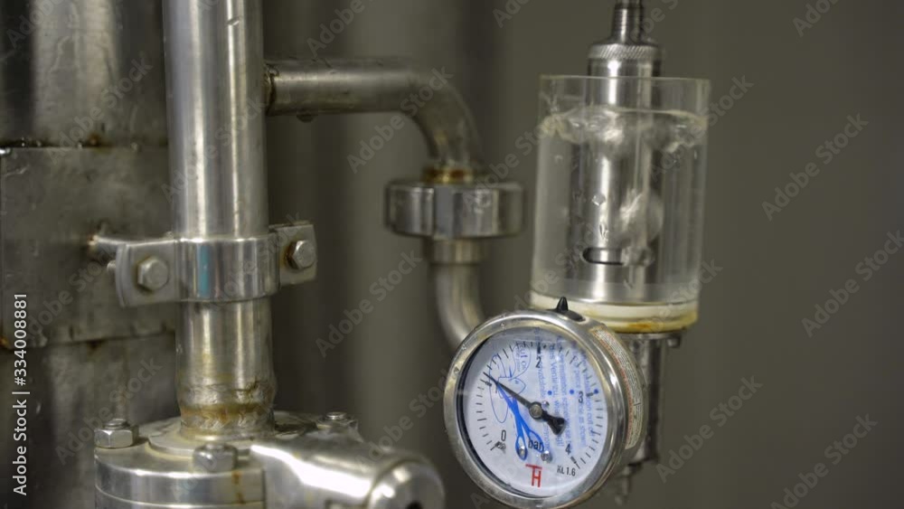 Close up of beer filling glass at brewery. Beer pouring out of tap reservoir tank. Quality control by technologist. Close up of beer filling glass at brewery. Beer pouring out of tap reservoir tank. Quality control by technologist.