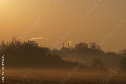 Misty sunrise with distant houses