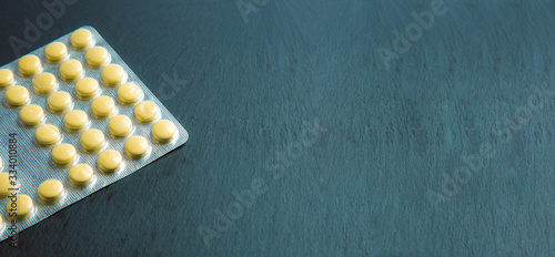 Website banner with yellow pills in the blister