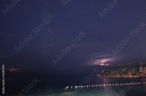  a beautiful sky above the sea rich in stars and lightning