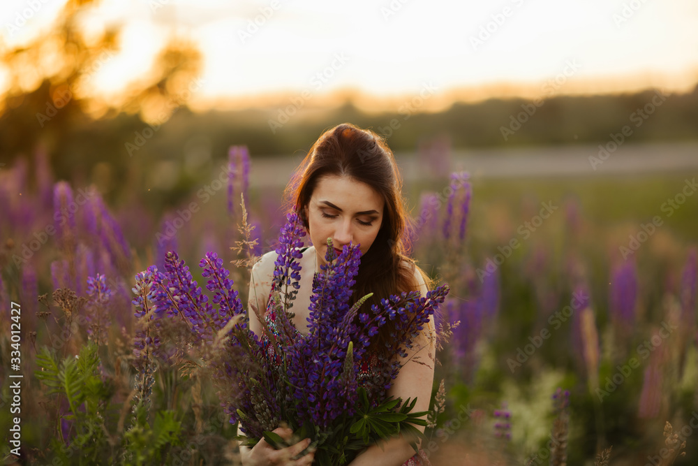 girl in a colored dress. Holds flowers in her hands girl in a colored dress. Holds flowers in her hands