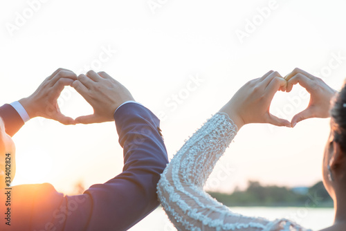 Women and men hold hands in the evening