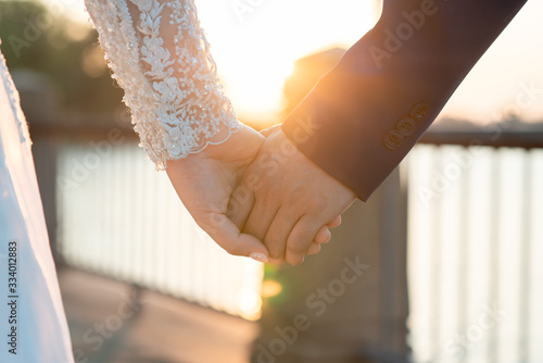 Women and men hold hands in the evening