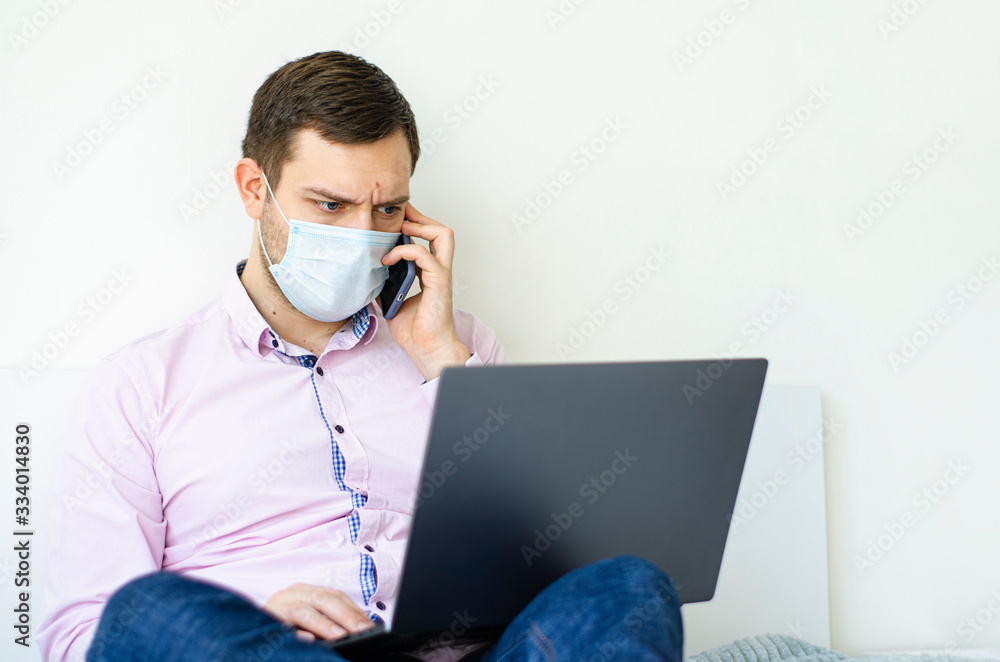 Coronavirus. Quarantine. A man in a shirt and jeans solves work issues remotely. Coronavirus. Quarantine. A man in a shirt and jeans solves work issues remotely.